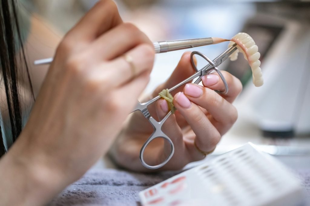 A technician crafting a dental prosthesis