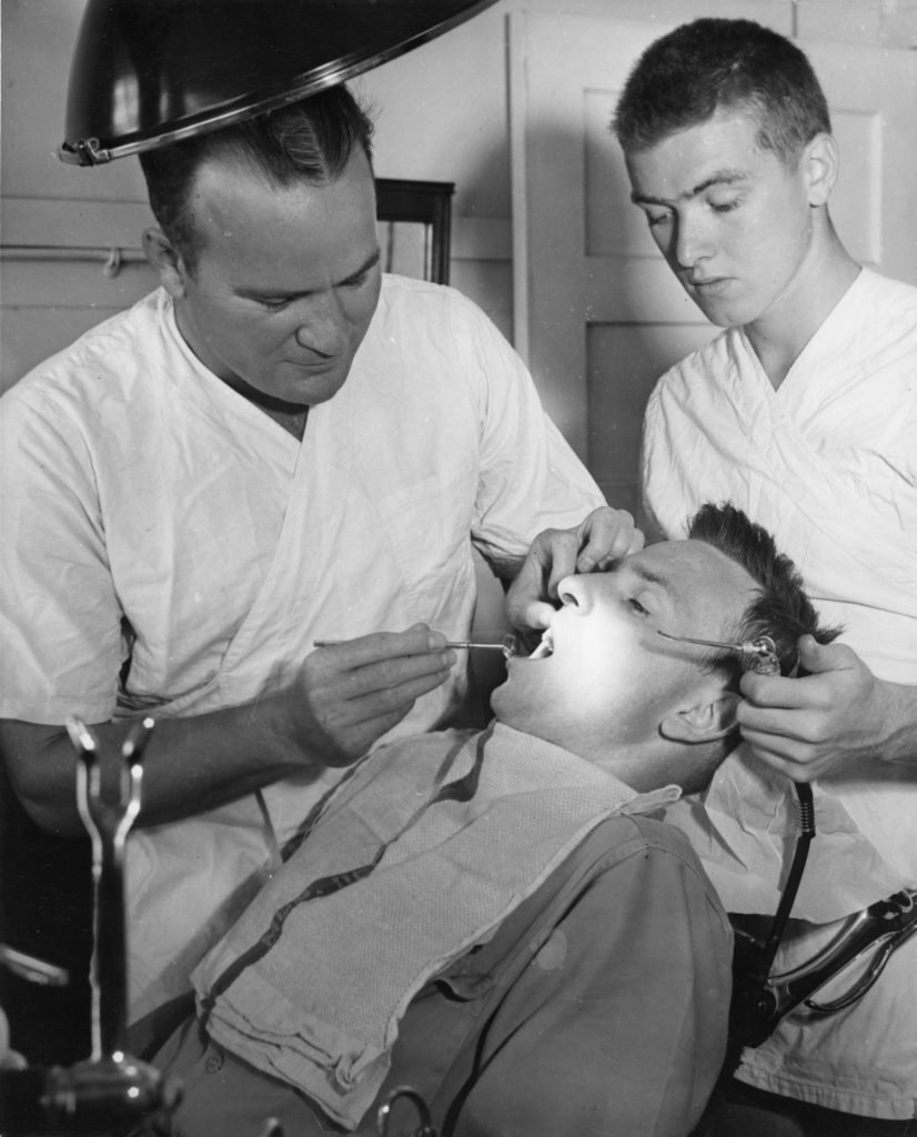 A dentist and assistant treating a patient